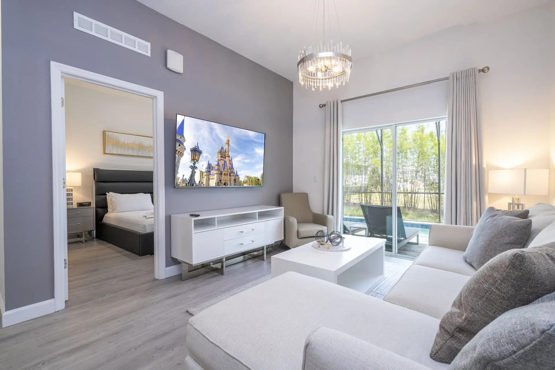 photo of living room with pool in back patio